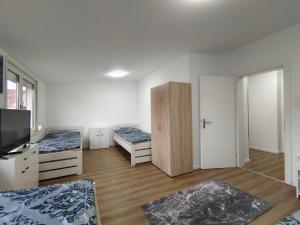 a room with two beds and a television in it at City House - up to 8 Persons in Kapfenberg