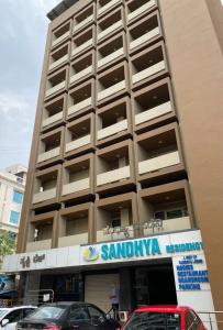 a tall building with a santa ana sign on it at Sandhya Residency in Bangalore
