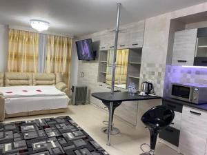 a bedroom with a bed and a table and a tv at Hotel Confort Drochia in Drochia