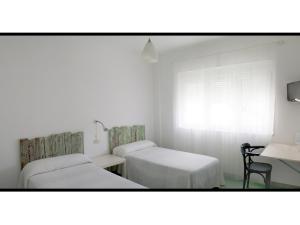 Postel nebo postele na pokoji v ubytování Hotel Langosteira