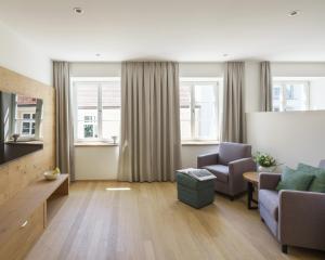 a living room with a couch and a chair at Küchlinhaus in Memmingen