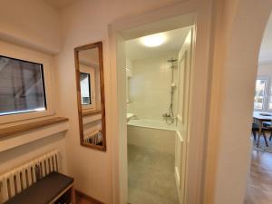 a bathroom with a walk in shower and a tub at BERG-LOVE in Garmisch-Partenkirchen