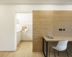 a dining room with a table and white chairs at Küchlinhaus in Memmingen +49 photos