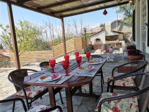 a wooden table with red wine glasses on a patio at Maronia Luxury Villa in Maronia