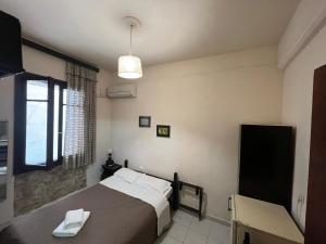 a bedroom with a large bed and a window at Rethymno House in Rethymno Town