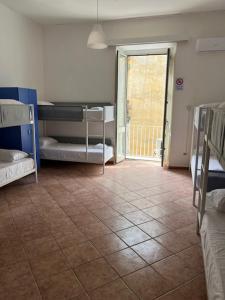 a room with bunk beds and a tile floor at Coremi in Naples