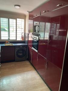 a kitchen with a stove and a washing machine at Cosy appartement in Casablanca