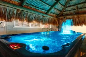 a large blue tub in a room with a waterfall at Twin Tiki 3 in St Pete Beach