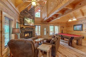 a living room with a pool table in a cabin at Lovers Hideaway in Gatlinburg