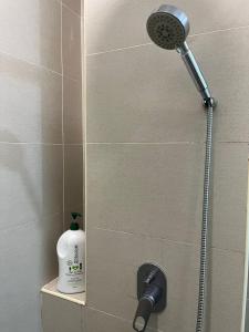 a shower with a shower head in a bathroom at Atlantis Sea View Unit in Malacca