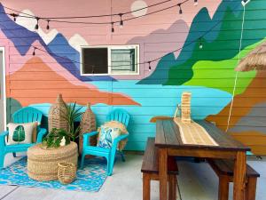 a colorful wall with two chairs and a wooden table at Boise White Water Guest House in Boise
