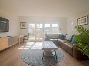 a living room with a couch and a table at Pass the Keys Town Centre cottage with garden and parking in Cheltenham