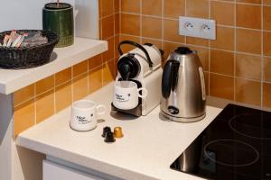 a kitchen counter with two coffee mugs on it at Balyam Suites Montorgueil - Sentier in Paris