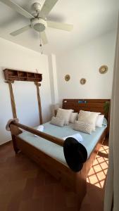 a bed in a room with a ceiling fan at Brisa Marinera in El Rompido