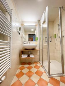 a bathroom with a sink and a shower at JUFA Hotel Deutschlandsberg in Deutschlandsberg