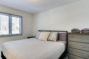 a bedroom with a bed with a dresser and a window at Breezy Point Cabin Deck with Golf Course Views! in Pequot Lakes