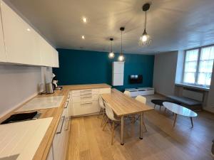 a kitchen with a table and a dining room at Appartement au coeur d'Arbois in Arbois