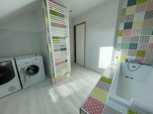 a laundry room with a washing machine and a washer at Appartement au coeur d'Arbois in Arbois