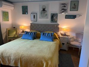 a bedroom with a large bed with blue pillows at Maison Du Soleil in Cima