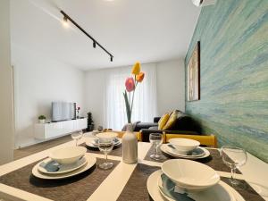 a dining room with a table and a couch at Apartments Valerian in Novigrad Istria