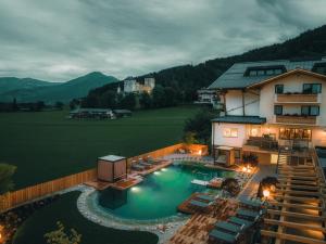 an aerial view of a house with a swimming pool at SOULSISTERS' Hotel in Kaprun