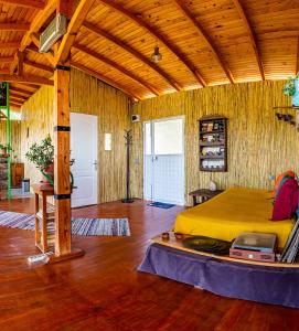 a bedroom with a large yellow bed in a room at Olabilir Houses in Ortaca