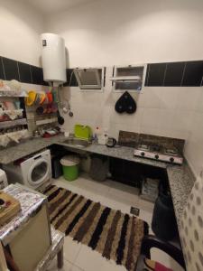a kitchen with a sink and a counter top at Miami Hotel in Cairo