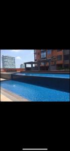 a picture of a swimming pool with buildings in the background at 2 BR Portovita Tower 12-A in Manila