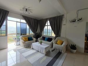 a living room with two chairs and a table at Dream 1 in Cameron Highlands