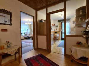 a living room with a door leading to a kitchen at Ferienwohnung Eckl in Bad Reichenhall +18 photos