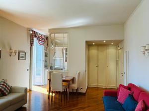 a living room with a table and a couch at BELLE ILE LAKE VIEW SUITE in Griante Cadenabbia