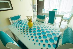 a dining room table with a vase of flowers on it at Chill Out Hotel in Tsqaltubo