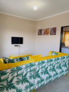 a living room with a yellow and white couch at Aaron’s apartments in Ladysmith