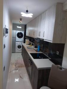 a kitchen with wooden cabinets and a white appliance at GOLDEN MOON in Aiándion