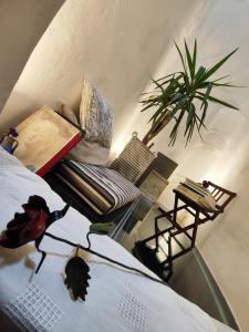 a room with a bed and a couch and a table at Casa degli Artisti in Citerna
