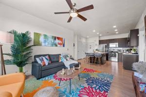 a living room with a couch and a ceiling fan at Downtown Walking Oasis with King BD and City View in Salt Lake City