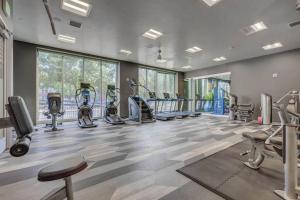 a gym with several treadmills and elliptical machines at Downtown Walking Oasis with King BD and City View in Salt Lake City