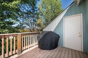 a black umbrella sitting on the deck of a house at Twin Rivers Vasquez 3 by Stay Winter Park in Fraser