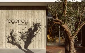 a shadow of a tree on the side of a building at Regency Boutique Hotel Holiday Suites in Paphos City