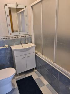 a bathroom with a toilet and a sink and a shower at Casa 28 in Pataias