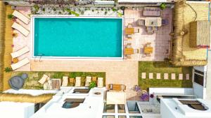 a large screen in a room with a pool at Wind Of Alaçatı Adult Only 13 in Çeşme