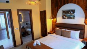 a bedroom with a large bed and a mirror at Wind Of Alaçatı Adult Only 13 in Çeşme