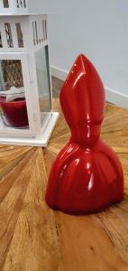 a red plastic chair sitting on a wooden floor at Suite dei Borboni - Appartamento in Naples