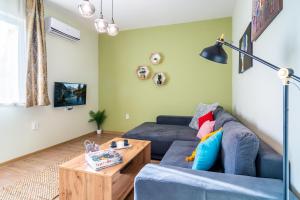 a living room with a blue couch and a coffee table at Madrid 2BDR w Free Parking near Metro, Serdika Mall in Sofia