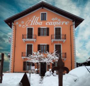 a building with an alalo cancer sign on it at Alba Camere Chiomonte in Chiomonte