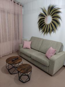 a living room with a couch and two tables at Portosin Lar in Goyanes