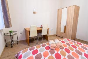 a bedroom with a bed and a table with chairs at Madrid 2BDR near Metro, Serdika Mall - ACs - Cot in Sofia