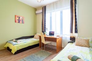 a bedroom with a desk and a bed and a window at Madrid 2BDR w Free Parking near Metro, Serdika Mall in Sofia