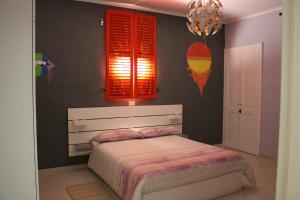 a bedroom with a bed and red shuttered windows at Alba Camere Chiomonte in Chiomonte