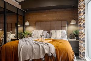 a bedroom with a large bed with a tray on it at Bailey Lodge in Padstow